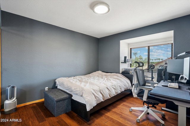 bedroom with dark wood-type flooring