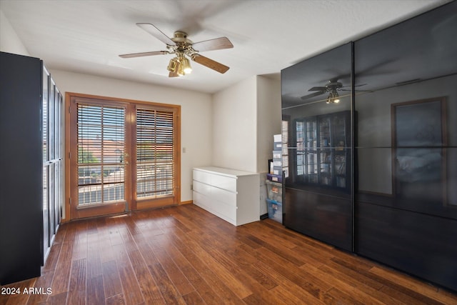 spare room featuring ceiling fan and dark wood-type flooring