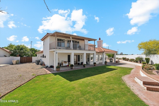 back of house featuring a yard, a patio, a balcony, and central AC unit