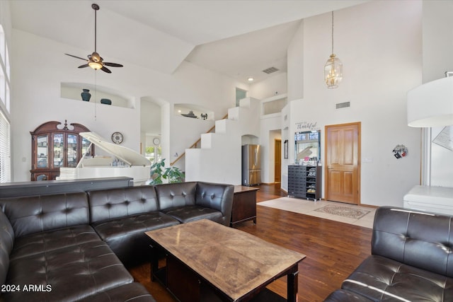 living room with ceiling fan, hardwood / wood-style floors, and high vaulted ceiling