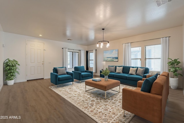 17313 N 185th Dr, Surprise, AZ 85374 - living area featuring a notable chandelier, visible vents, baseboards, and wood finished floors