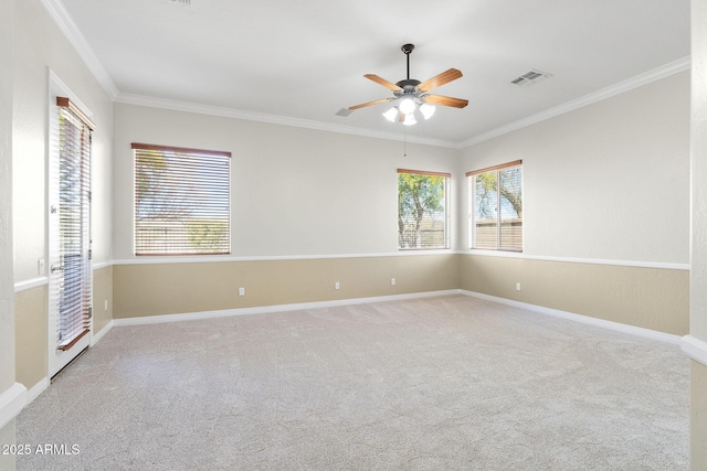 carpeted empty room featuring ornamental molding and ceiling fan