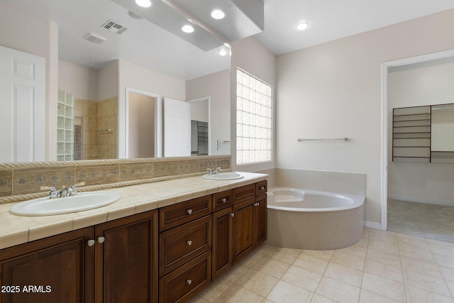 bathroom featuring vanity, tile patterned flooring, and separate shower and tub