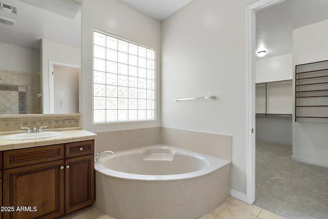 bathroom with tile patterned flooring, vanity, and plus walk in shower