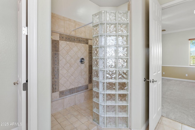 bathroom with tile patterned flooring, ornamental molding, and tiled shower