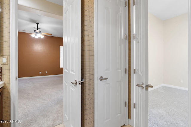 hallway featuring light colored carpet