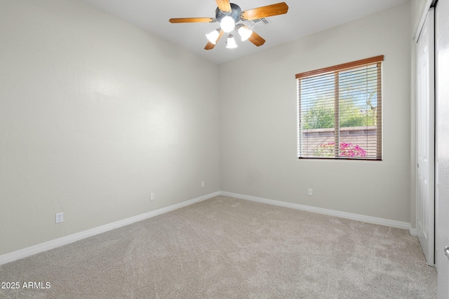 unfurnished room featuring ceiling fan and light colored carpet