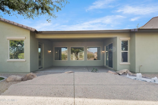 doorway to property featuring a patio area