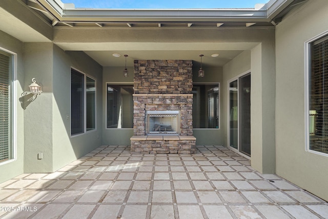 view of patio featuring an outdoor stone fireplace