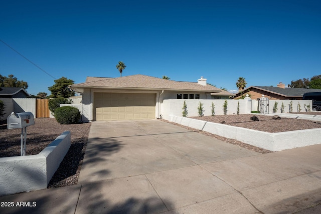 view of front of home with a gate, an attached garage, driveway, and fence