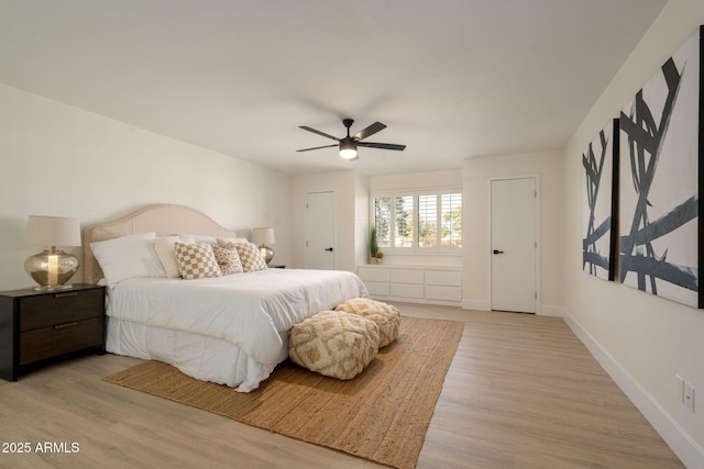 bedroom featuring light wood finished floors, ceiling fan, and baseboards