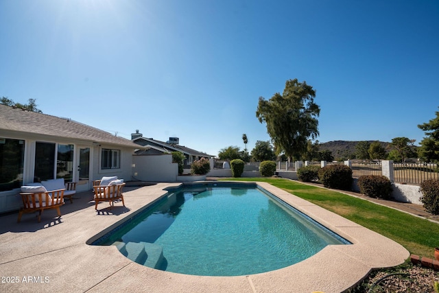 view of pool featuring a patio area, a fenced in pool, and fence