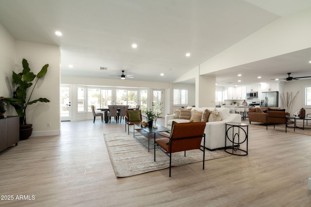 living area with recessed lighting, light wood-style floors, visible vents, and baseboards