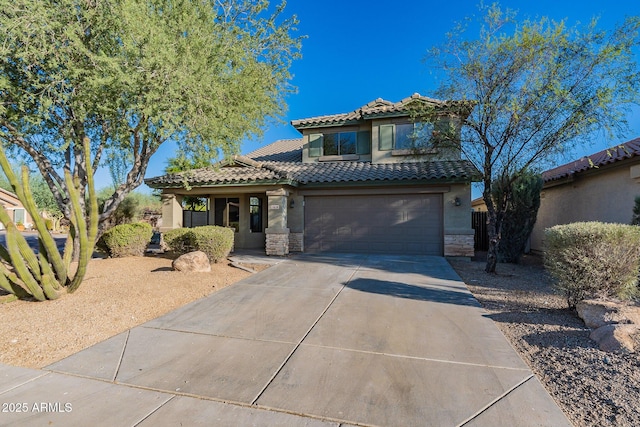 mediterranean / spanish-style home with a garage