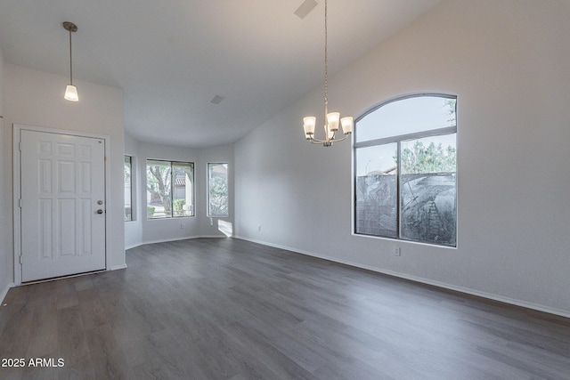 interior space featuring dark wood-type flooring, high vaulted ceiling, and a chandelier