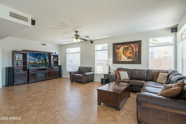 tiled living room with ceiling fan