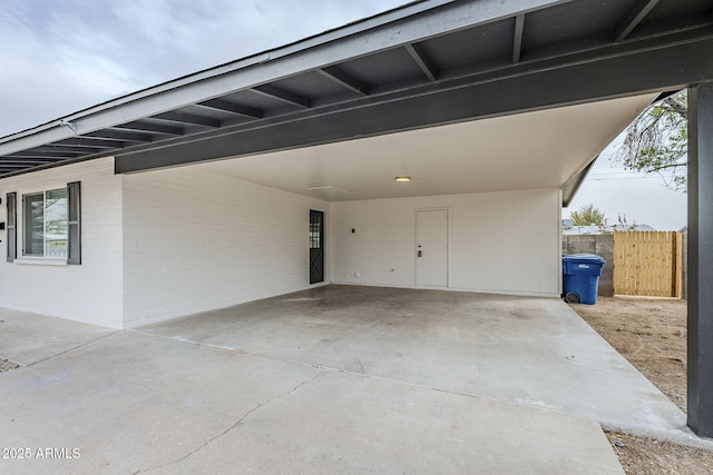 view of patio / terrace featuring an attached carport and fence