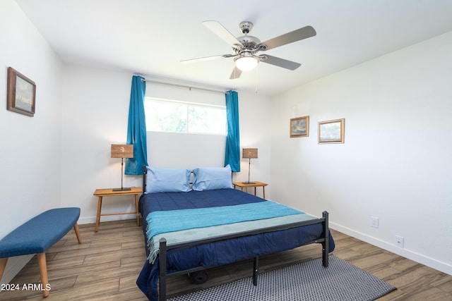 bedroom with hardwood / wood-style flooring and ceiling fan