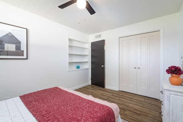 bedroom with a closet, ceiling fan, and dark hardwood / wood-style floors