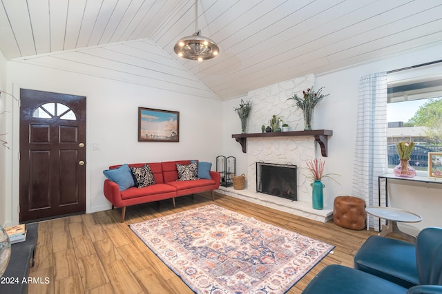 living room with wooden ceiling, a notable chandelier, a fireplace, hardwood / wood-style floors, and lofted ceiling