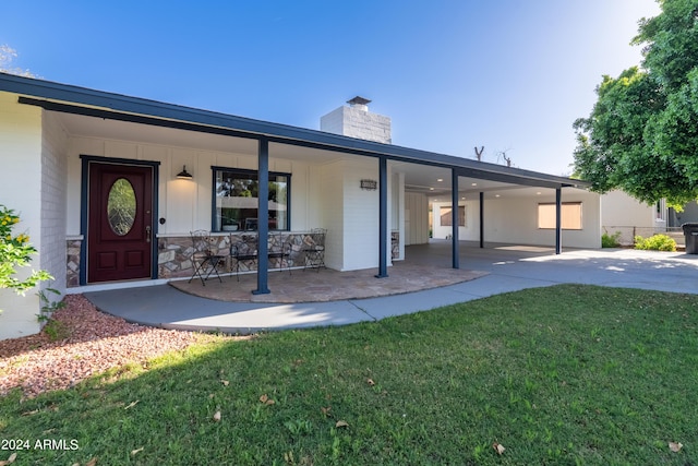 exterior space with covered porch and a front yard