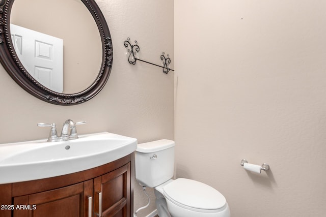 bathroom with toilet and vanity