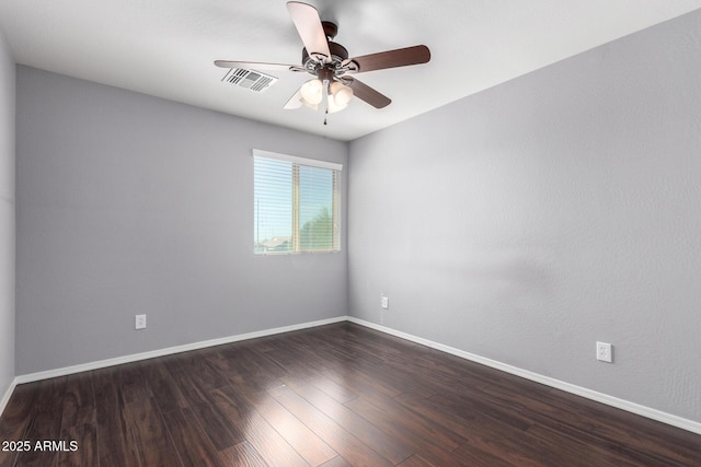 unfurnished room featuring baseboards, dark wood-style floors, visible vents, and a ceiling fan