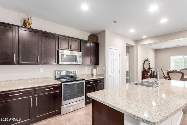 kitchen with light countertops, recessed lighting, a sink, dark brown cabinetry, and appliances with stainless steel finishes