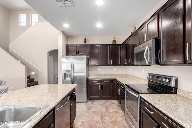 kitchen featuring visible vents, light countertops, a sink, and stainless steel appliances