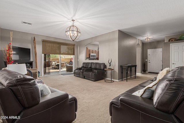 carpeted living room featuring a chandelier