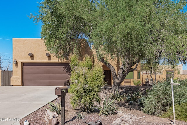 adobe home featuring a garage