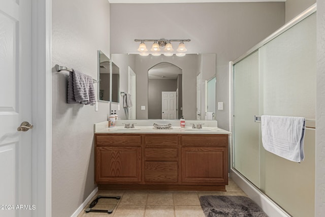 bathroom featuring vanity, tile patterned flooring, and an enclosed shower