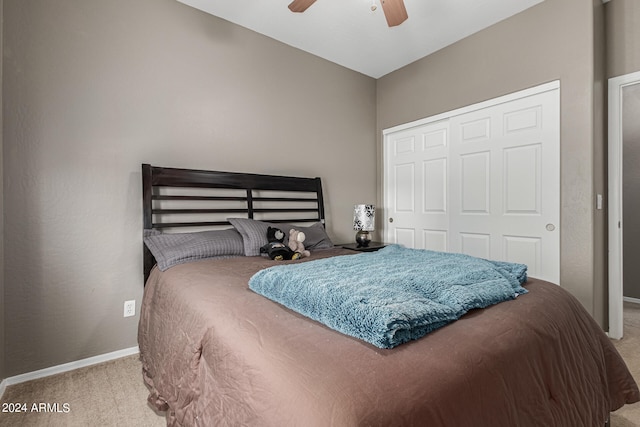 carpeted bedroom featuring a closet and ceiling fan