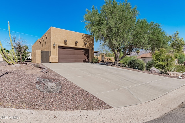 pueblo revival-style home featuring a garage