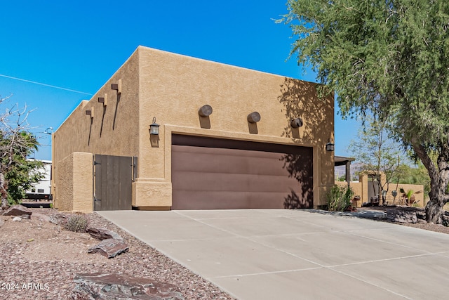 pueblo revival-style home with a garage