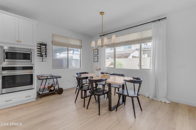 dining room featuring a notable chandelier and light hardwood / wood-style floors