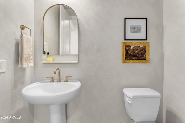 bathroom featuring sink and toilet