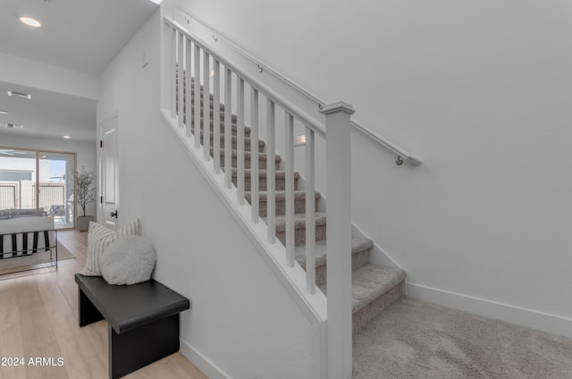 stairway featuring hardwood / wood-style floors