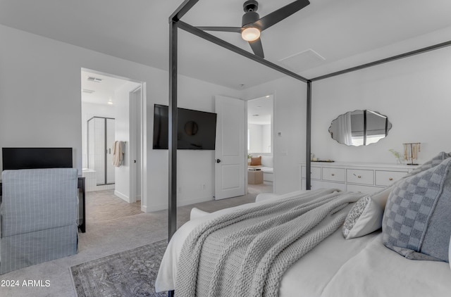 bedroom with light carpet, ceiling fan, and ensuite bath