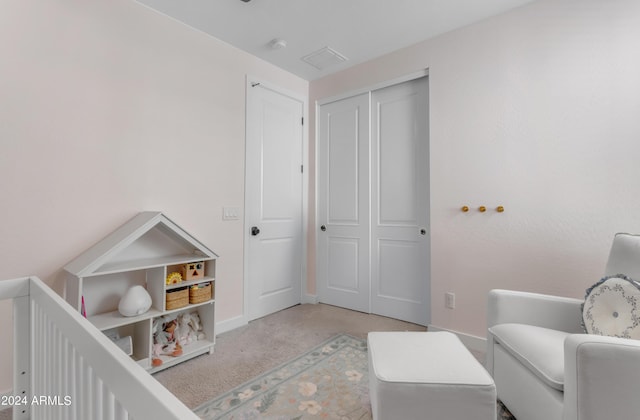 bedroom featuring a closet and light carpet