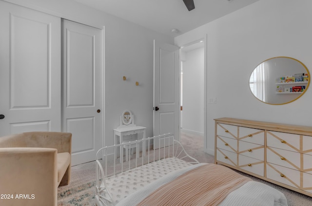 carpeted bedroom featuring ceiling fan and a closet