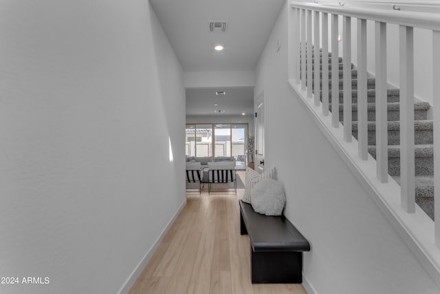 hallway with light hardwood / wood-style floors