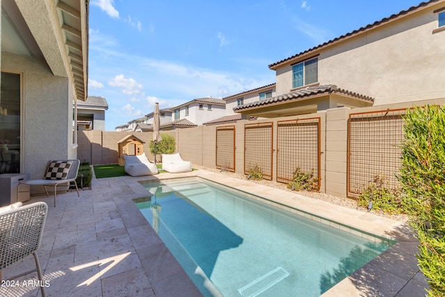 view of swimming pool with a patio area