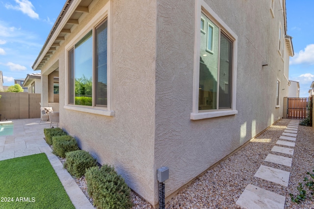 view of side of property featuring a patio