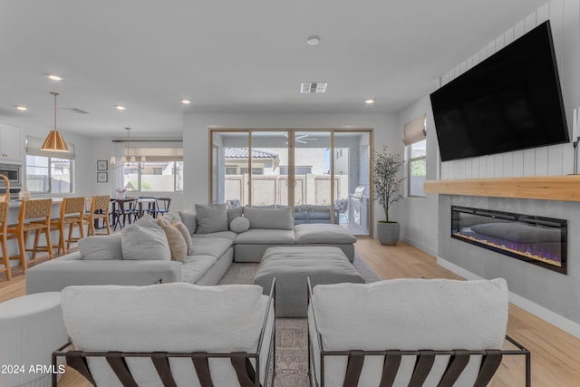 living room with light hardwood / wood-style flooring and a wealth of natural light