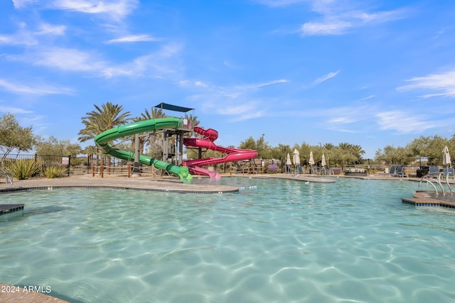 view of swimming pool with a water slide