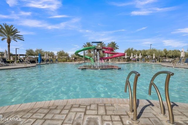 view of swimming pool with a water slide