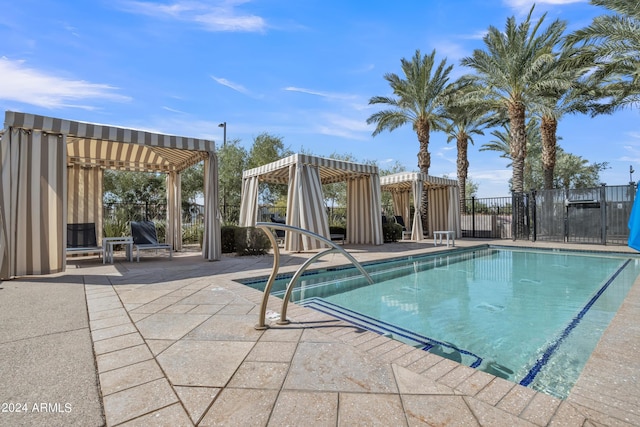 view of pool with a pergola and a patio area