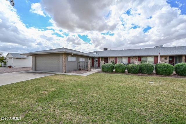 ranch-style house featuring brick siding, fence, concrete driveway, a front yard, and an attached garage