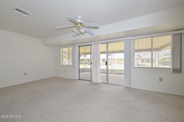 spare room with a ceiling fan and visible vents